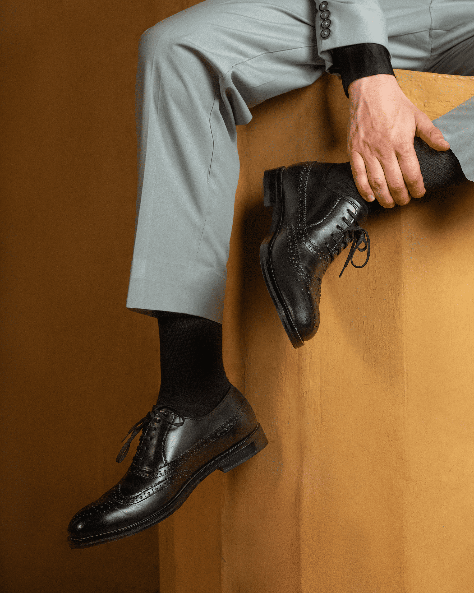 man wearing black brogue shoes